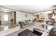 Open-concept living room flowing into the dining area, filled with natural light and comfortable furnishings at 8206 Bull Run Ct, Indianapolis, IN 46227