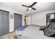 Relaxing bedroom features a dark ceiling fan, neutral walls, and spacious closet doors at 8206 Bull Run Ct, Indianapolis, IN 46227
