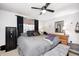 A modern bedroom with a cozy bed, ceiling fan and dresser at 8206 Bull Run Ct, Indianapolis, IN 46227
