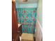Small bathroom with colorful floral shower curtain and beige flooring at 852 Walnut St, Greenfield, IN 46140
