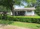 Charming single-story home with a cozy front porch and lush, green landscaping enhancing curb appeal at 852 Walnut St, Greenfield, IN 46140