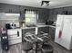 Grey kitchen with a table in the center and natural light creating a modern and functional space at 852 Walnut St, Greenfield, IN 46140