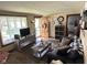 Inviting living room with wood-look flooring, a neutral color scheme, and natural light from a large window at 852 Walnut St, Greenfield, IN 46140