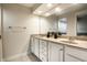 Bathroom features a double vanity with white cabinets, bright lighting, and a large mirror at 8690 Jaffa Ct W Dr # 28, Indianapolis, IN 46260