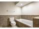 Clean bathroom featuring a bathtub, toilet, and tiled walls at 8690 Jaffa Ct W Dr # 28, Indianapolis, IN 46260