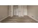Empty bedroom featuring closet with double doors and wood laminate flooring at 8690 Jaffa Ct W Dr # 28, Indianapolis, IN 46260