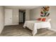Bedroom featuring a bed, a doorway, and closet doors. Light gray wall with modern art at 8690 Jaffa Ct W Dr # 28, Indianapolis, IN 46260