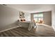 Cozy bedroom with natural light from the window, complemented by a simple bed and bright orange pillows at 8690 Jaffa Ct W Dr # 28, Indianapolis, IN 46260