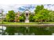 Stunning exterior view of a brick condo building with water feature and lush green landscaping at 8690 Jaffa Ct W Dr # 28, Indianapolis, IN 46260