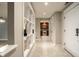 Inviting hallway with tiled floor and a view of the kitchen, enhancing the home's flow at 8690 Jaffa Ct W Dr # 28, Indianapolis, IN 46260