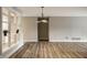 Open-concept living room boasts hardwood floors and modern lighting, creating a bright and inviting space at 8690 Jaffa Ct W Dr # 28, Indianapolis, IN 46260
