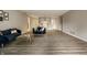 Open-concept living room with hardwood floors, offering a versatile space for living and entertaining at 8690 Jaffa Ct W Dr # 28, Indianapolis, IN 46260