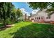 Beautiful back yard featuring large lawn, mature trees, and fence line at 9158 Oak Knoll Ln, Fishers, IN 46037