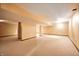 Finished basement with neutral carpet, ceilings with spotlights, pillars and beige walls at 9158 Oak Knoll Ln, Fishers, IN 46037