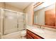 Bathroom featuring a vanity with granite countertop and a bathtub with sliding glass doors at 9158 Oak Knoll Ln, Fishers, IN 46037
