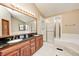 Elegant bathroom with double sink vanity, large mirror, and glass enclosed shower at 9158 Oak Knoll Ln, Fishers, IN 46037