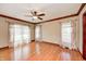 Bright bedroom with hardwood floors and decorative curtains at 9158 Oak Knoll Ln, Fishers, IN 46037