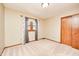 An empty bedroom featuring neutral walls, carpet, window, curtain and a wooden closet at 9158 Oak Knoll Ln, Fishers, IN 46037