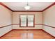 Well-lit room with hardwood floors, trim and a large window overlooking backyard at 9158 Oak Knoll Ln, Fishers, IN 46037