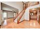 Spacious foyer boasts hardwood floors, staircase with carpet, and views into the living and kitchen areas at 9158 Oak Knoll Ln, Fishers, IN 46037
