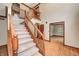 Entryway featuring carpeted stairs, wood trim, and views to an adjacent room with wood flooring at 9158 Oak Knoll Ln, Fishers, IN 46037