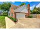 Traditional brick home with manicured lawn, attached garage and sidewalk at 9158 Oak Knoll Ln, Fishers, IN 46037