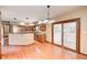 Open-concept kitchen with stainless steel appliances, wood cabinets, and a breakfast bar overlooking the dining area at 9158 Oak Knoll Ln, Fishers, IN 46037