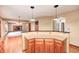 Open concept kitchen with breakfast bar that views the living room with fireplace at 9158 Oak Knoll Ln, Fishers, IN 46037
