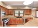 Well-lit kitchen equipped with stainless steel appliances, tiled backsplash, and stylish countertops at 9158 Oak Knoll Ln, Fishers, IN 46037