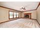 Bright living room with neutral carpet, brick fireplace, and large window overlooking the backyard at 9158 Oak Knoll Ln, Fishers, IN 46037