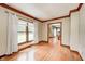 Living room with hardwood floors, large window, and decorative molding and view to the foyer at 9158 Oak Knoll Ln, Fishers, IN 46037