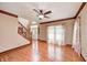 Bright living room with hardwood floors, staircase, and a front entrance at 9158 Oak Knoll Ln, Fishers, IN 46037