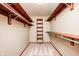Walk-in closet with custom shelving and hanging rods for optimal storage at 9158 Oak Knoll Ln, Fishers, IN 46037