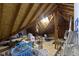 This attic space features exposed rafters with a skylight and is used for storage in this home at 974 Arrowwood Dr, Carmel, IN 46033