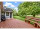 Wooden back deck with built-in bench seating overlooking a large green lawn and a gazebo at 974 Arrowwood Dr, Carmel, IN 46033