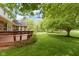 A wooden deck overlooks a backyard and a beautiful green lawn at 974 Arrowwood Dr, Carmel, IN 46033