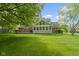 Beautiful backyard showcasing a sunroom that overlooks a lush green lawn at 974 Arrowwood Dr, Carmel, IN 46033