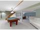 Spacious finished basement with a pool table, dining table, and white sofa at 974 Arrowwood Dr, Carmel, IN 46033