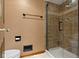 The cozy bathroom features a tiled shower with glass doors and a toilet on top of neutral tiled floors at 974 Arrowwood Dr, Carmel, IN 46033