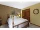 This cozy bedroom has neutral walls, trim and carpet, and a closet with wood-stained doors at 974 Arrowwood Dr, Carmel, IN 46033