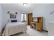 Bright bedroom with a cozy bed, desk, and ample natural light from the window at 974 Arrowwood Dr, Carmel, IN 46033