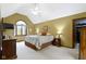Bedroom showcasing a neutral color scheme, vaulted ceiling, and large window providing natural light at 974 Arrowwood Dr, Carmel, IN 46033