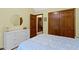 This neutral bedroom has wooden closet doors and neutral walls and trim at 974 Arrowwood Dr, Carmel, IN 46033