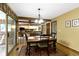 Open dining area with access to the kitchen, living room, and bright sunroom at 974 Arrowwood Dr, Carmel, IN 46033