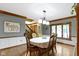 Cozy dining room with wood floors, a decorative table setting, and trim throughout at 974 Arrowwood Dr, Carmel, IN 46033