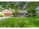 Beautifully landscaped front yard with a classic brick and siding home at 974 Arrowwood Dr, Carmel, IN 46033
