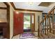 Welcoming foyer with a staircase, tiled floor, and decorative wood trim at 974 Arrowwood Dr, Carmel, IN 46033
