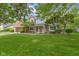 Charming two-story brick home with a well-maintained lawn and mature landscaping at 974 Arrowwood Dr, Carmel, IN 46033