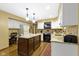 Well-lit kitchen with granite countertops, white cabinets, and center island at 974 Arrowwood Dr, Carmel, IN 46033