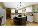 Well-lit kitchen featuring white cabinets, granite countertops, a kitchen island, and stainless steel appliances at 974 Arrowwood Dr, Carmel, IN 46033
